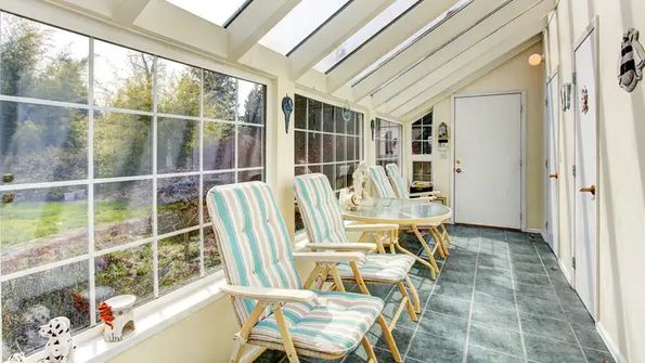 Bright sunroom with glass walls and ceiling