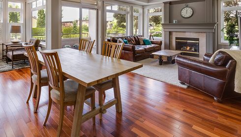 Spacious living and dining area with polished hardwood floors