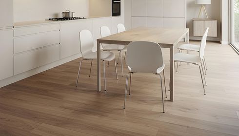 Dining area with light wood flooring and table with chairs