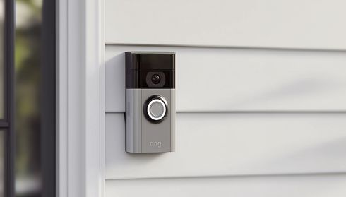 Smart doorbell camera mounted on a light gray house exterior