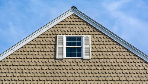 House gable with tan scalloped siding
