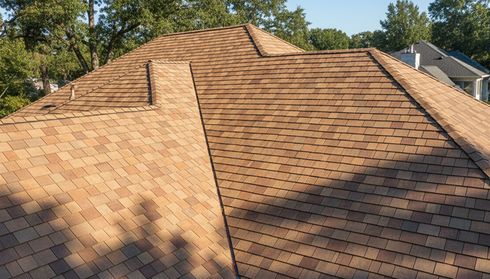 Aerial view of a house roof with brown cedar shingles