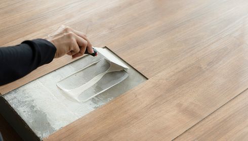 Installing vinyl flooring with adhesive