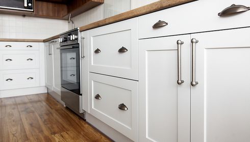 Lower cabinets with new handles in kitchen