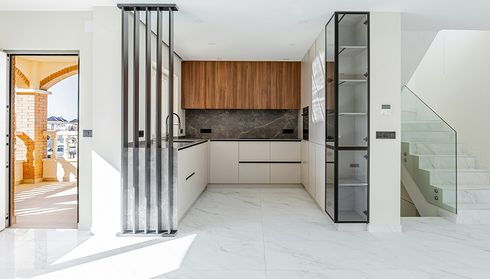 Modern kitchen with light tile and wood-look flooring