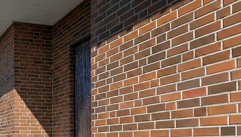 Red brick house siding close-up