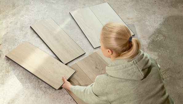Person arranging vinyl flooring panels